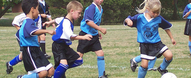 five 8-year-old kids playing soccer